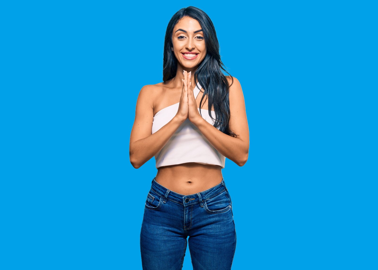 Beautiful hispanic woman wearing casual clothes praying with hands together asking for forgiveness smiling confident.